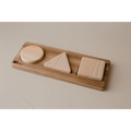 Wooden shape sorter toy with three geometric blocks.