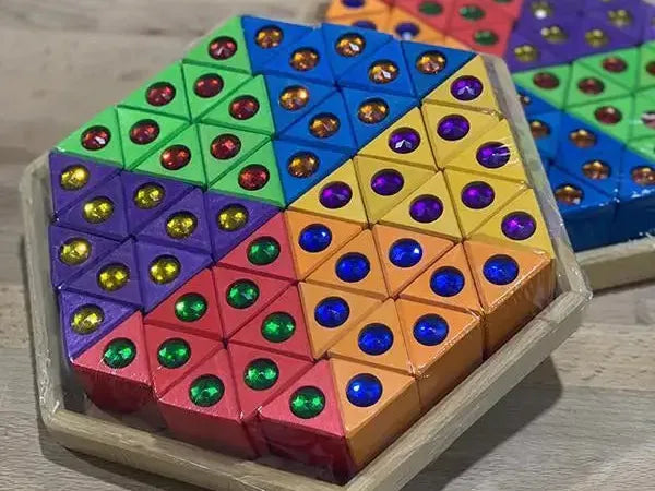 Colorful hexagonal puzzle or game board with triangular sections containing embedded colored dots.