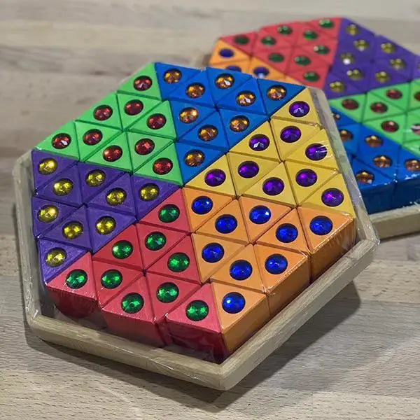 Colorful hexagonal puzzle or game board with triangular sections containing embedded colored dots.