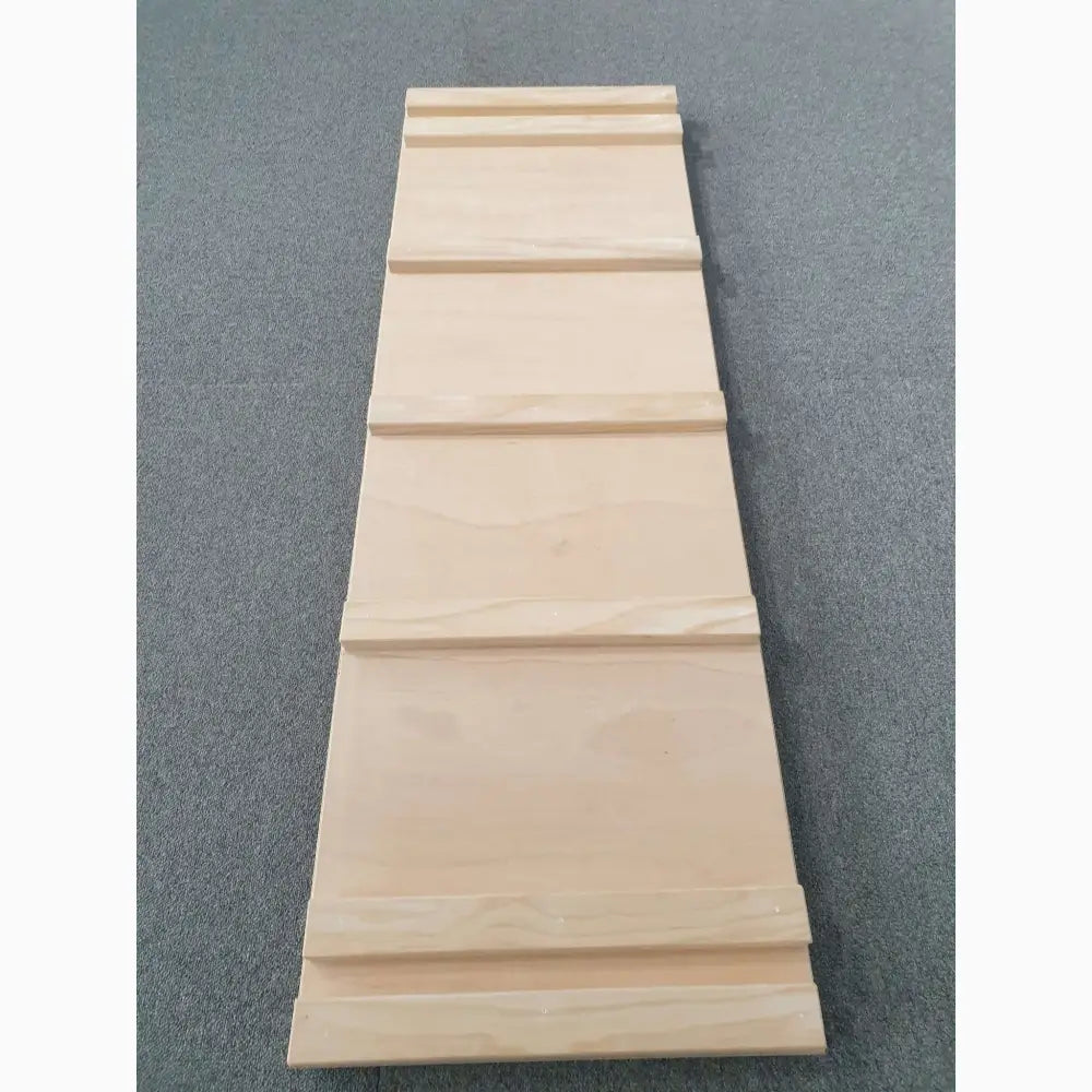 Wooden plank with grooved sections forming a tapered shape.