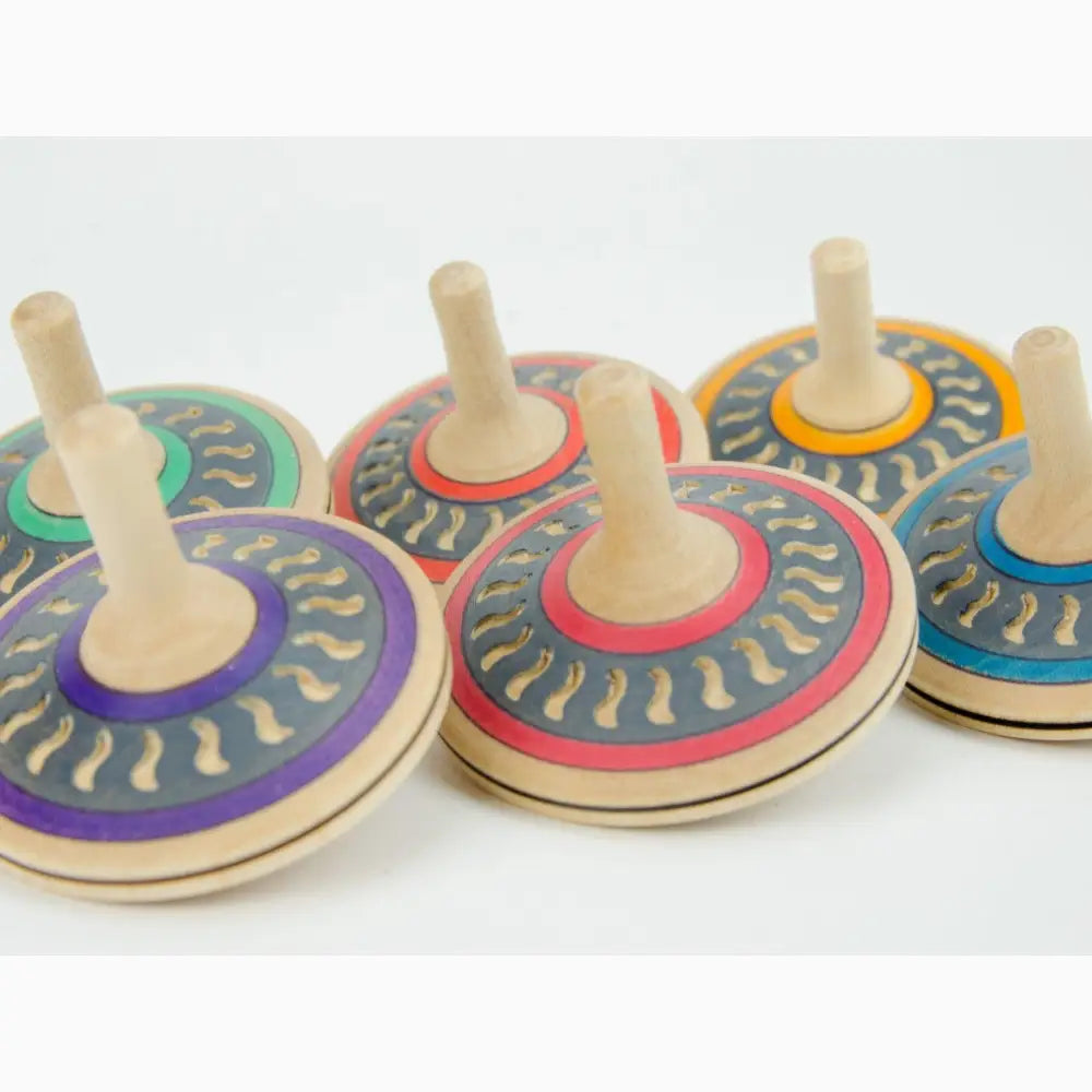 Colorful wooden spinning tops with circular designs.