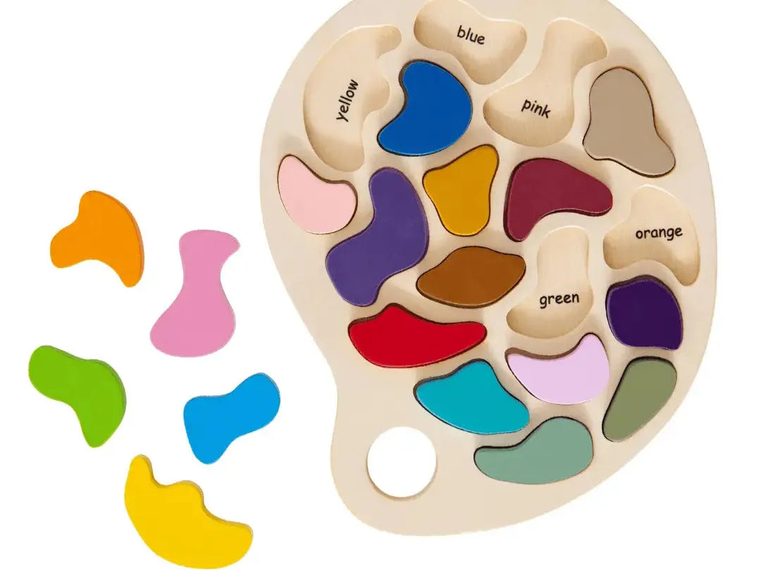 Wooden palette-shaped puzzle with colorful abstract pieces representing different colors.