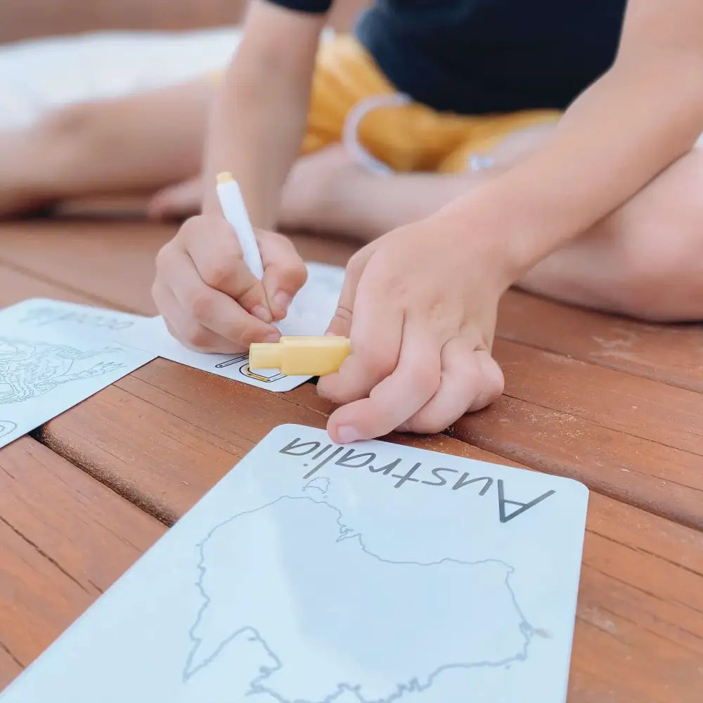 Map of Australia being drawn or traced on paper.