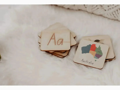 Wooden educational tiles featuring the letter ’Aa’ and a colorful map of Australia.