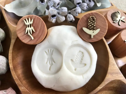 Clay or ceramic mold with two circular impressions for creating decorative patterns.