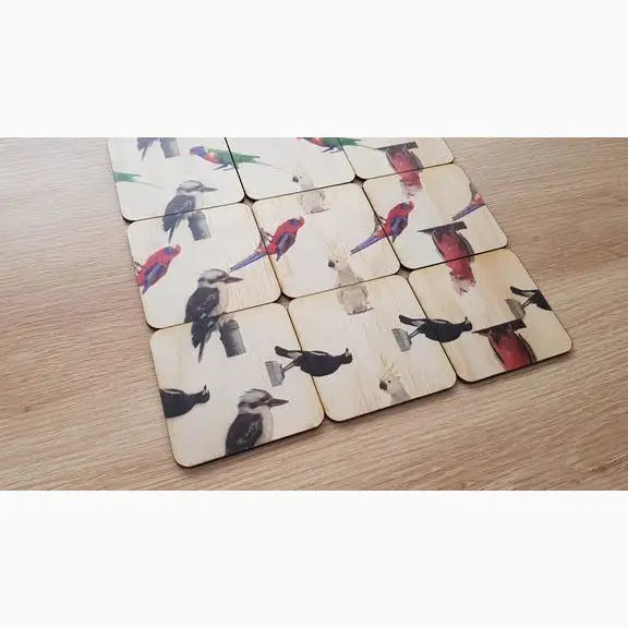 Set of wooden coasters with bird designs printed on them.