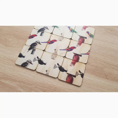 Set of square coasters with bird and flower designs.