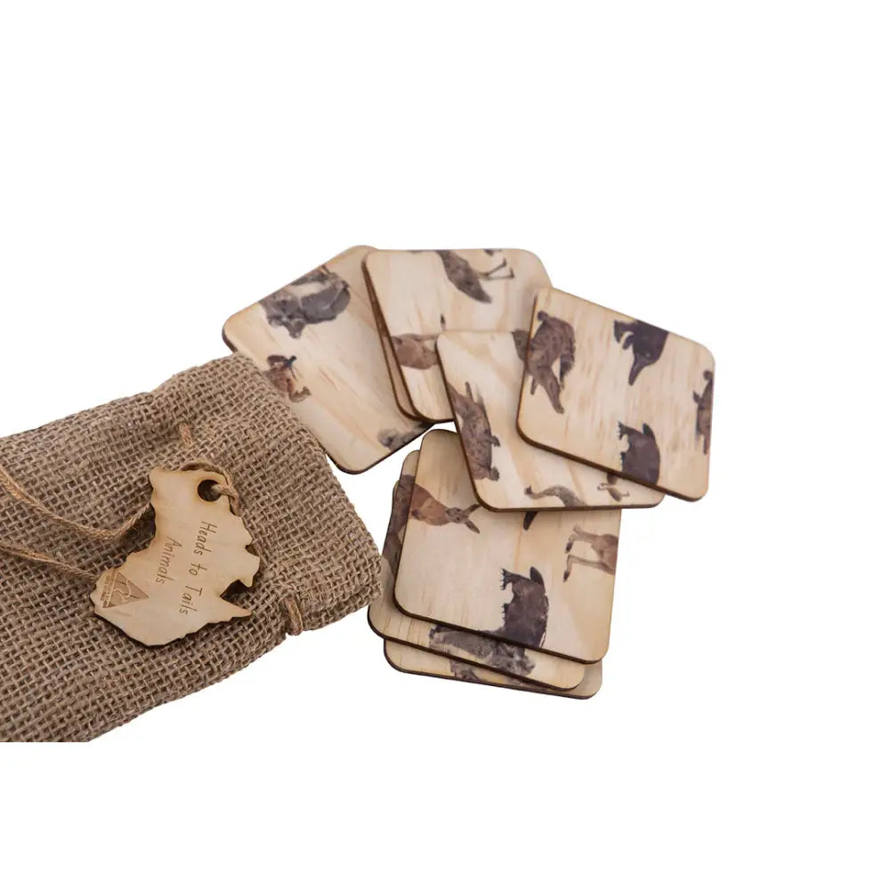 Set of coasters with cat designs on a light background, accompanied by a burlap pouch.