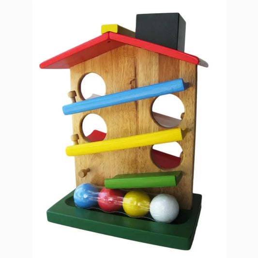 Wooden toy house with colorful ramps and balls.