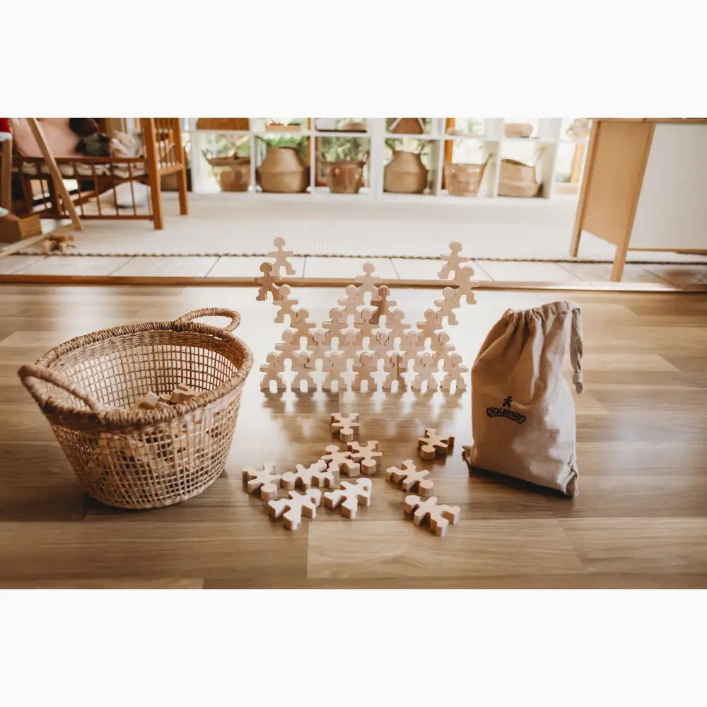 Wooden puzzle pieces arranged in a stacked formation on a floor.