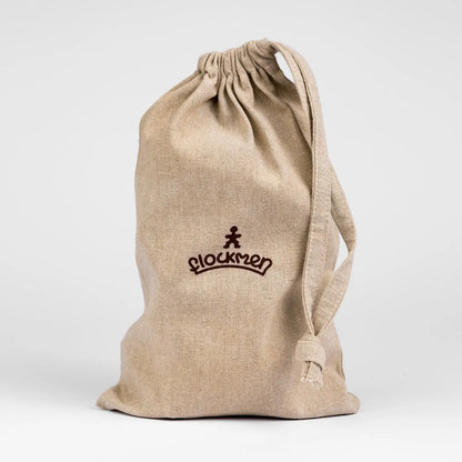 Beige drawstring bag with ’Blockmen’ logo printed on it.