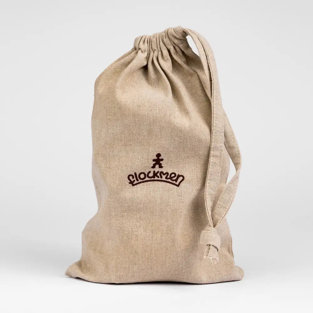 Beige drawstring bag with ’Blockmen’ logo printed on it.