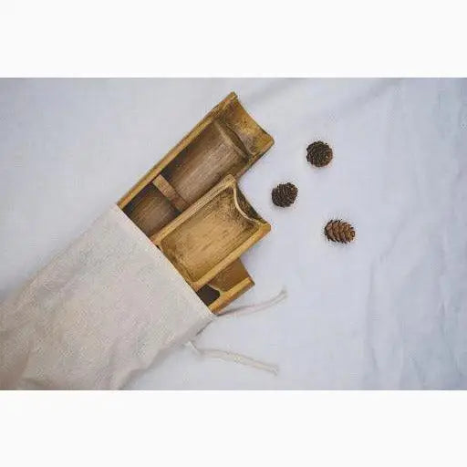 Bamboo serving trays in a cloth bag.