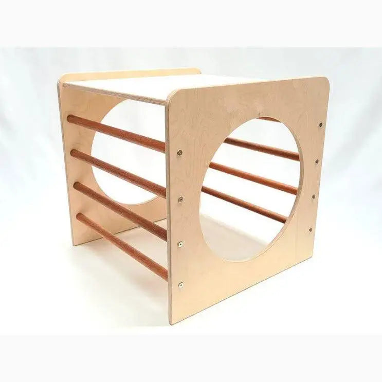 Wooden cube-shaped structure with circular cutouts and horizontal bars.