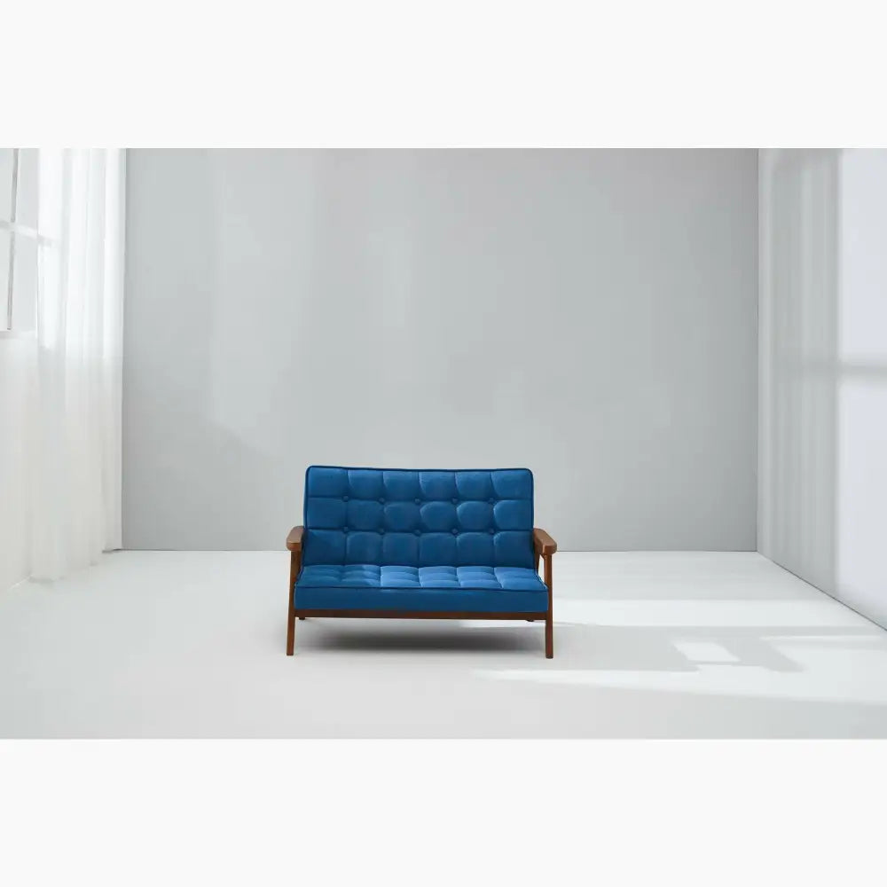 Blue tufted loveseat with wooden arms and frame.