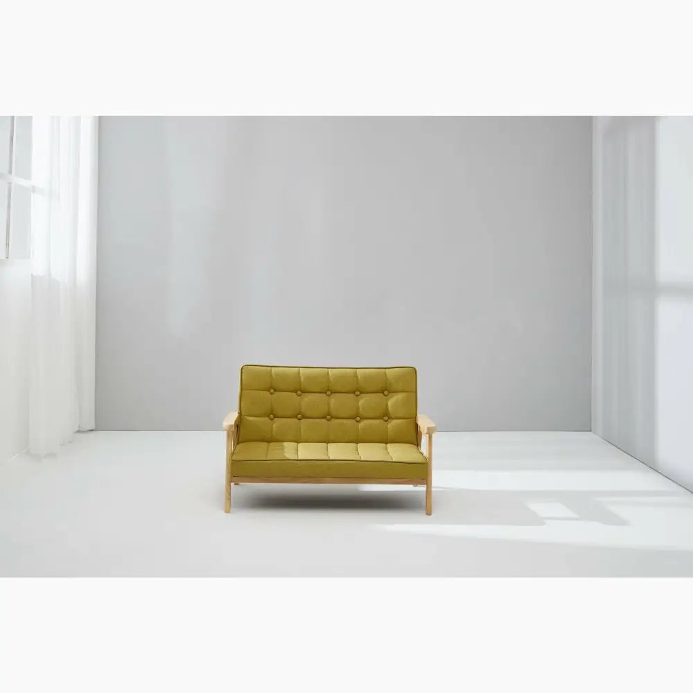 Yellow tufted loveseat with wooden frame.