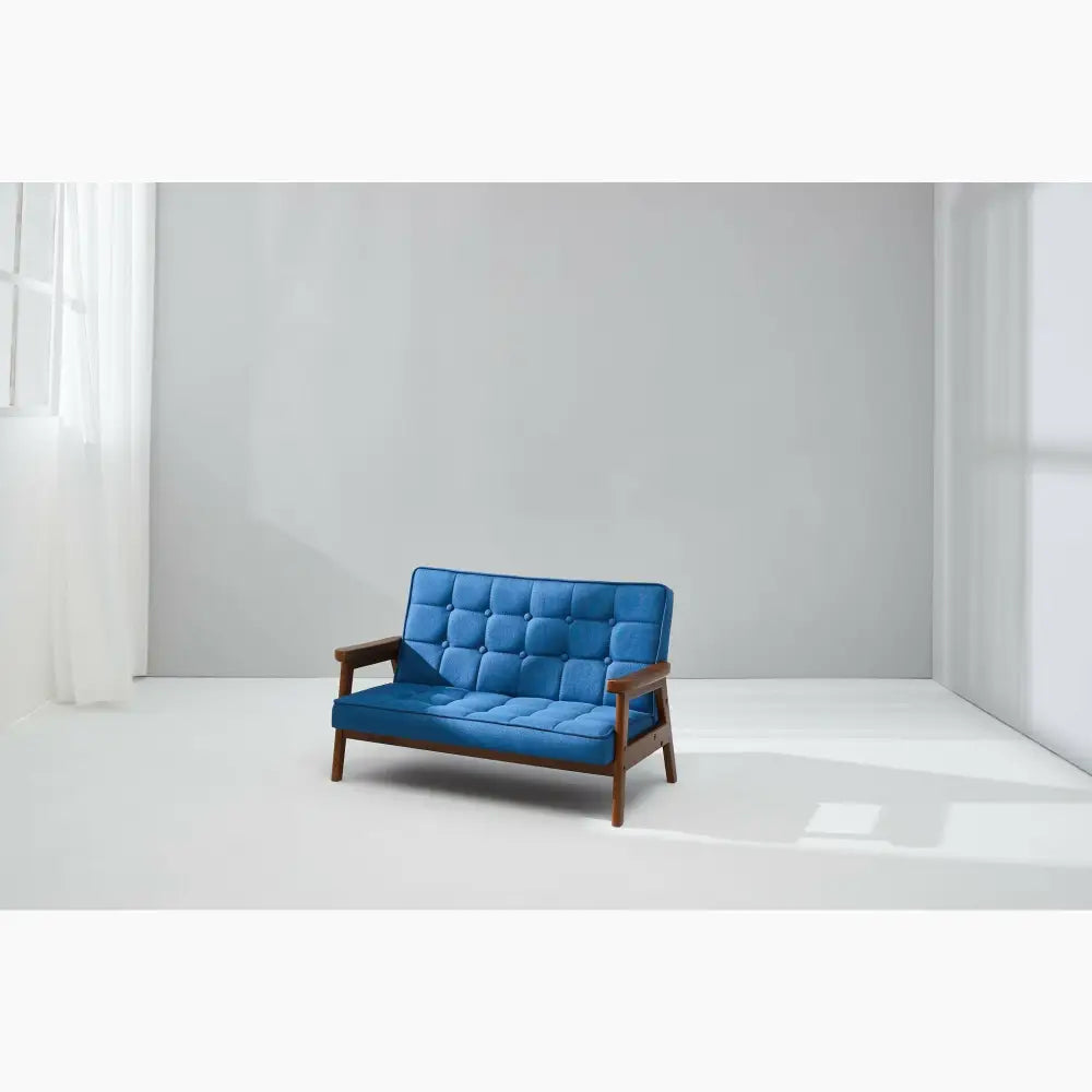 Blue tufted loveseat with wooden frame and armrests.