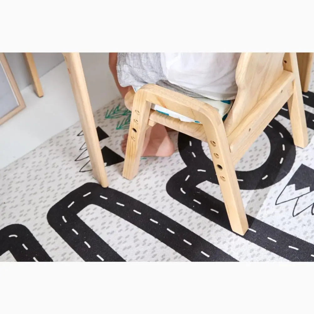 Wooden chair or stool with visible legs on a patterned rug.