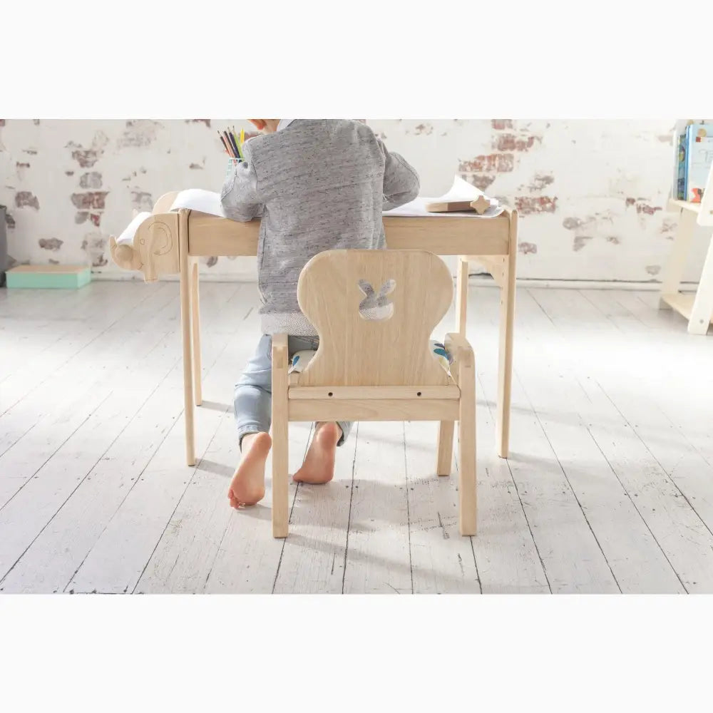 Child-sized wooden desk and chair set.