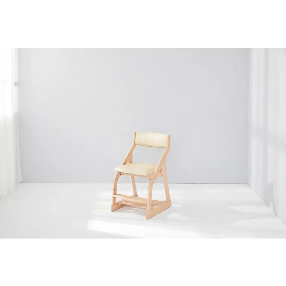 Wooden chair with a light-colored seat and backrest.