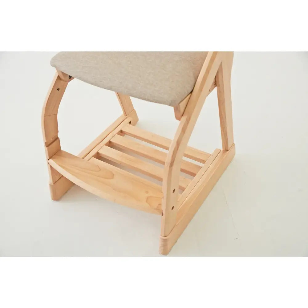 Wooden chair with a light-colored cushioned seat and slatted lower shelf.