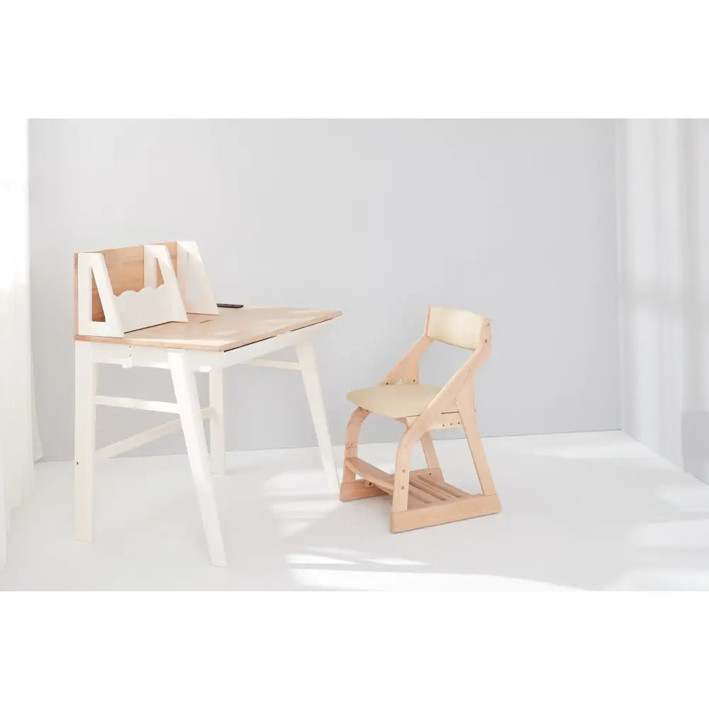 Minimalist wooden desk with an attached backboard and a matching chair.