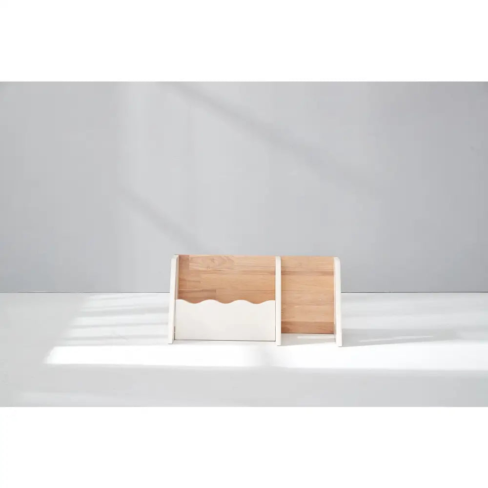 Wooden desk organizer or file holder with a wavy cutout design.