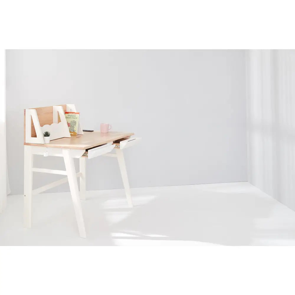 Minimalist white desk with an angled top and built-in storage compartment.