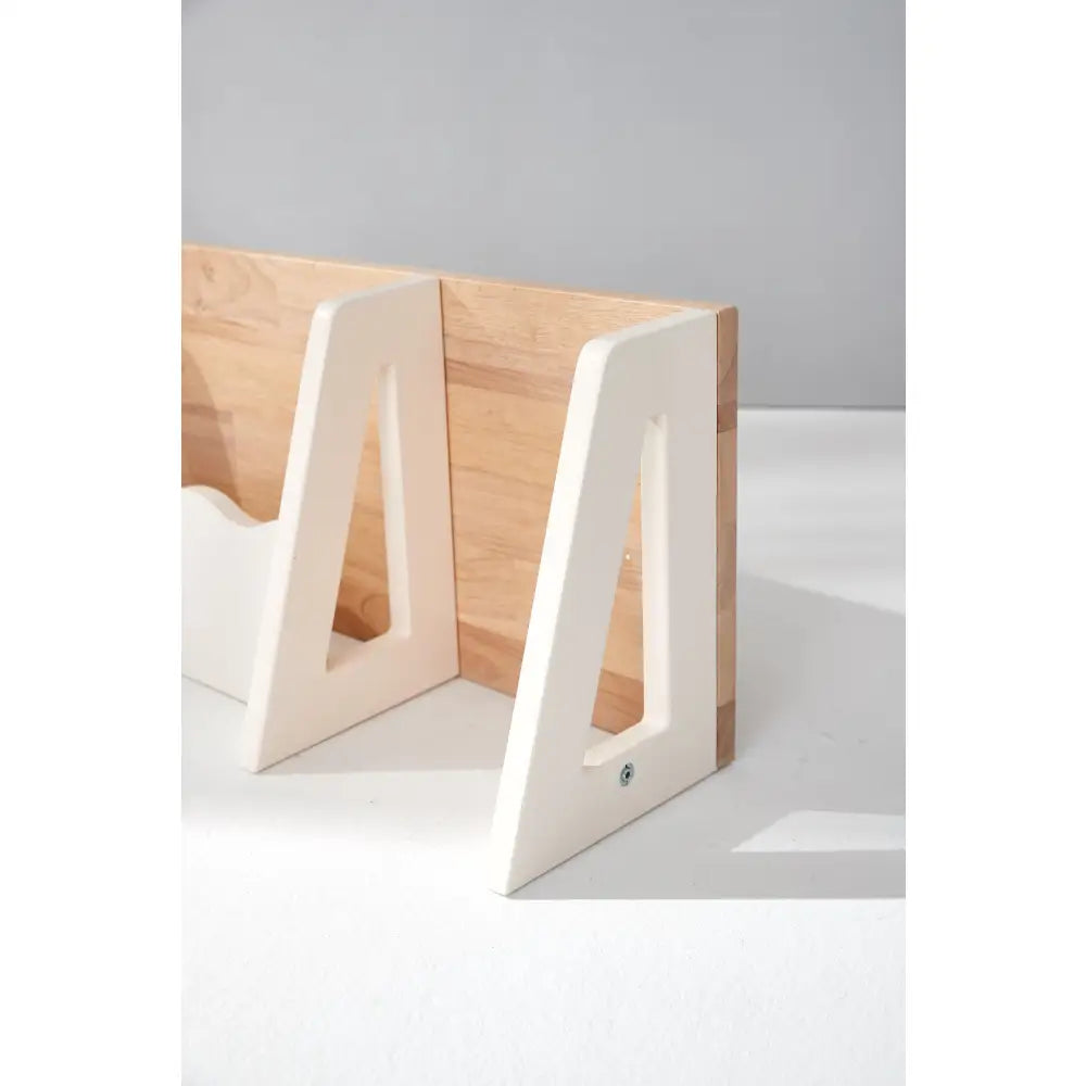 Minimalist wooden bookends with white-painted interior edges.