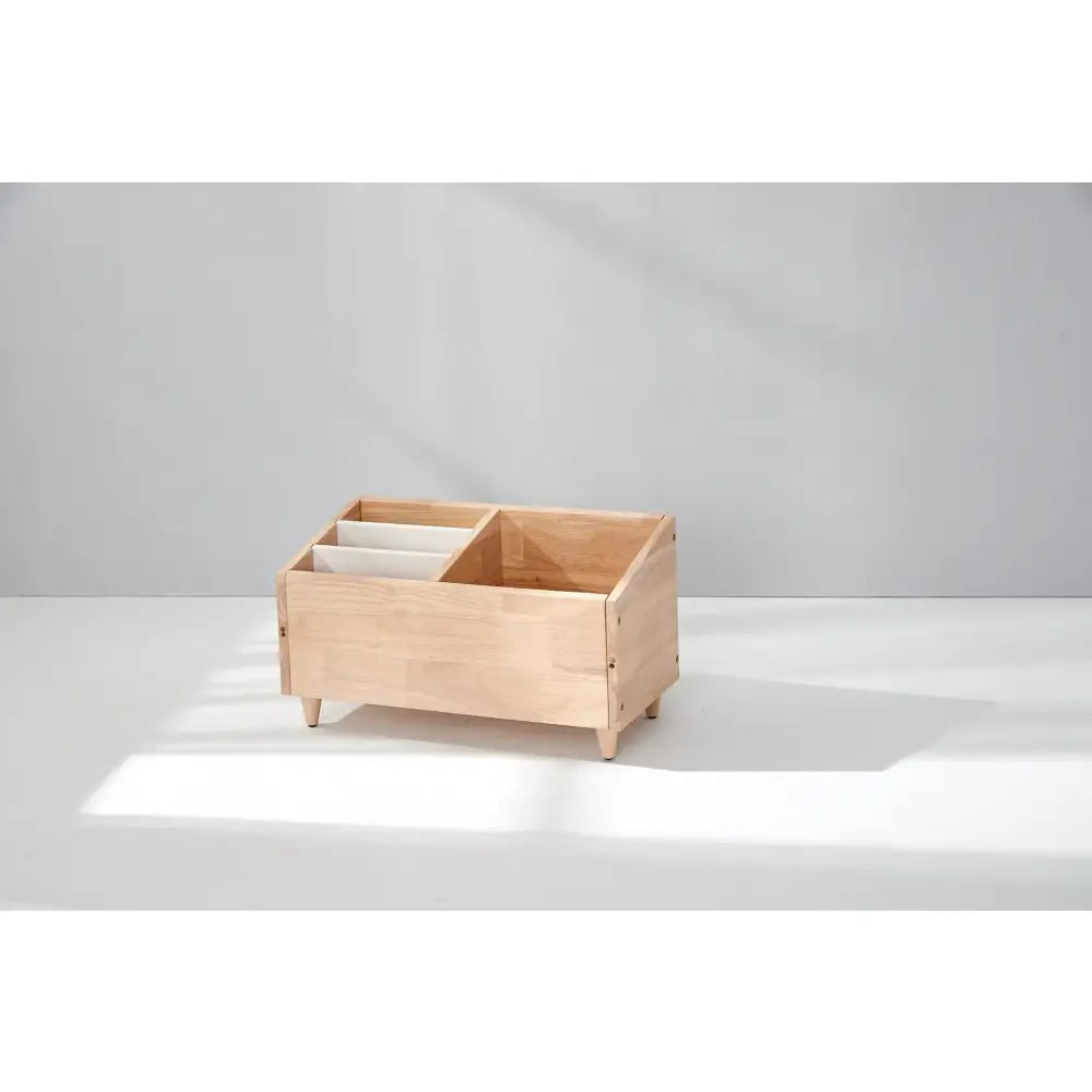 Wooden storage box with compartments on short legs.