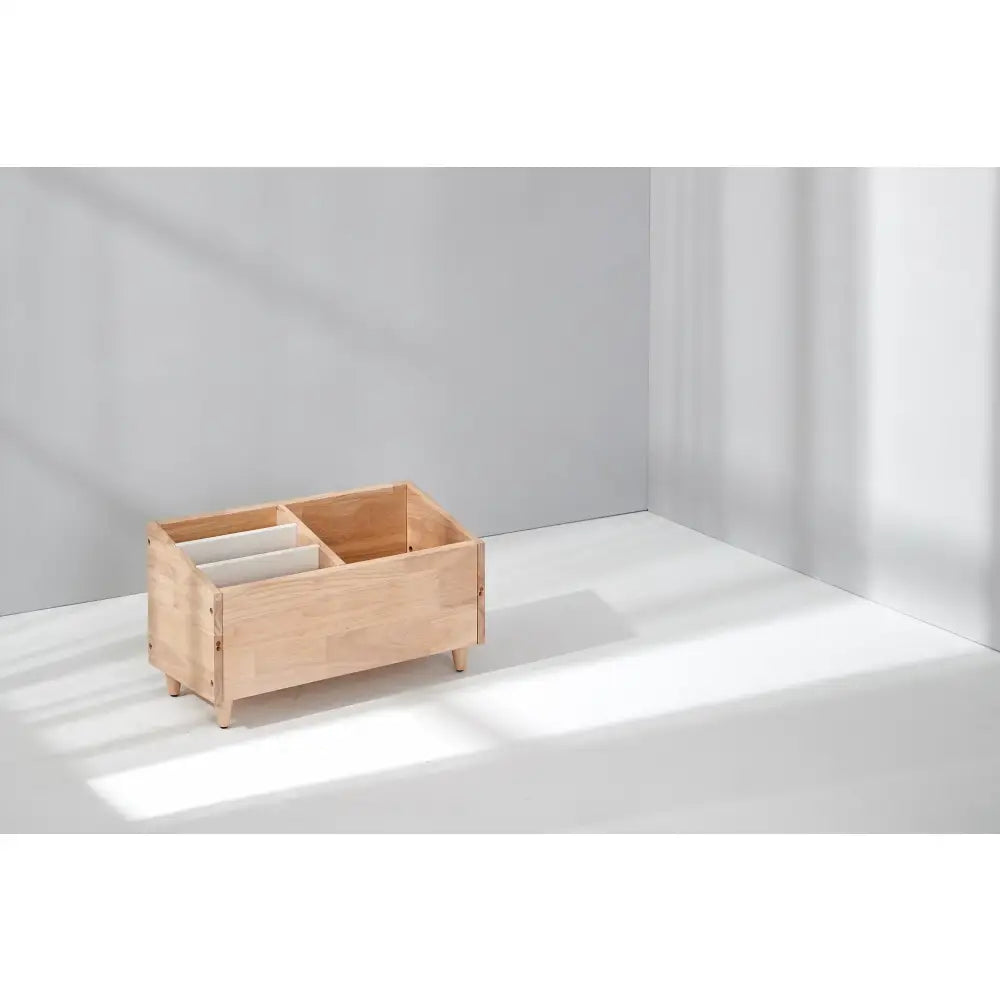 Wooden storage box with compartments and short legs.