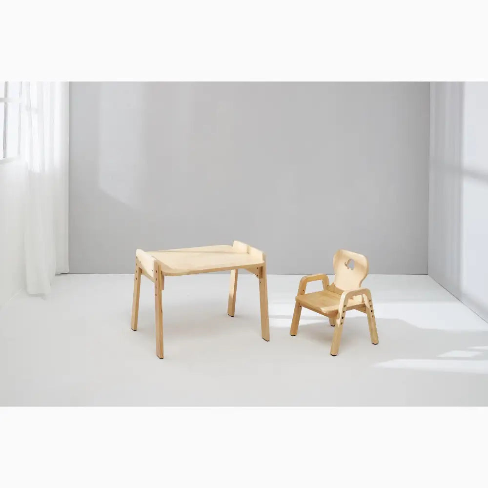 Wooden children’s desk and chair set with minimalist design.