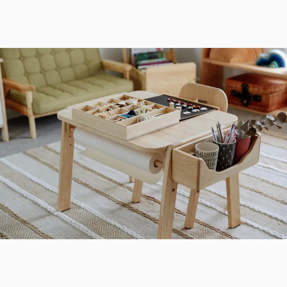 Wooden children’s activity table with built-in storage compartments and attached organizer.