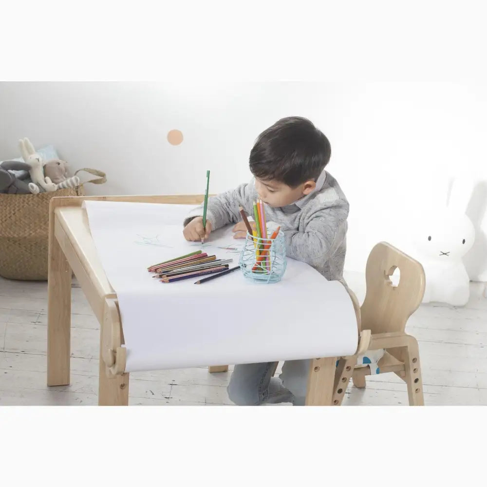 Child-sized wooden desk and chair set designed for drawing or writing activities.