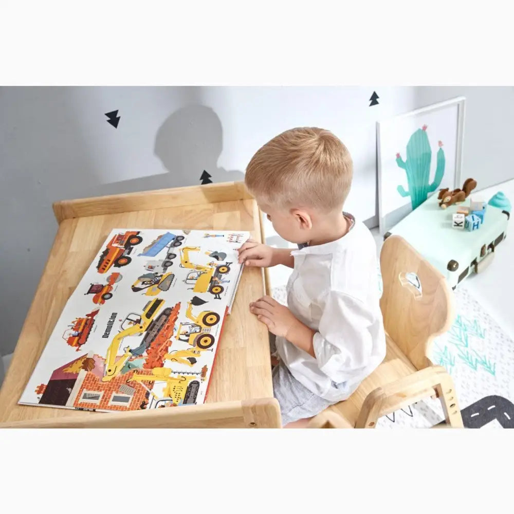 Young child working on a colorful vehicle-themed puzzle or activity board.