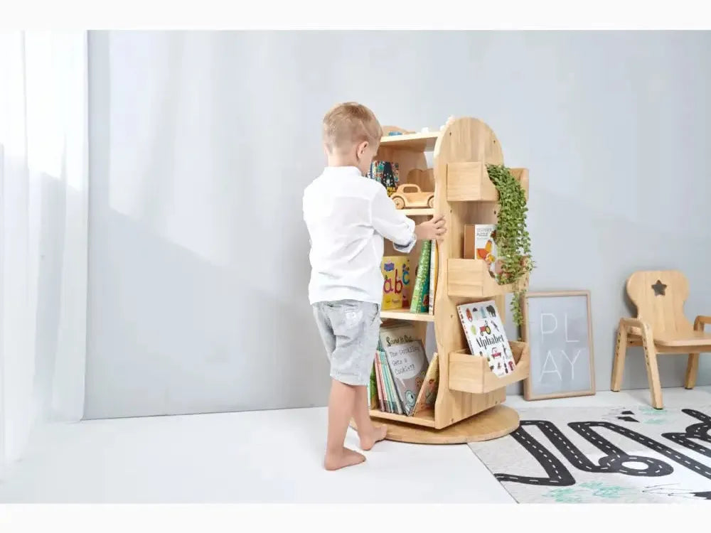 Wooden tree-shaped bookshelf with multiple shelves for storage.