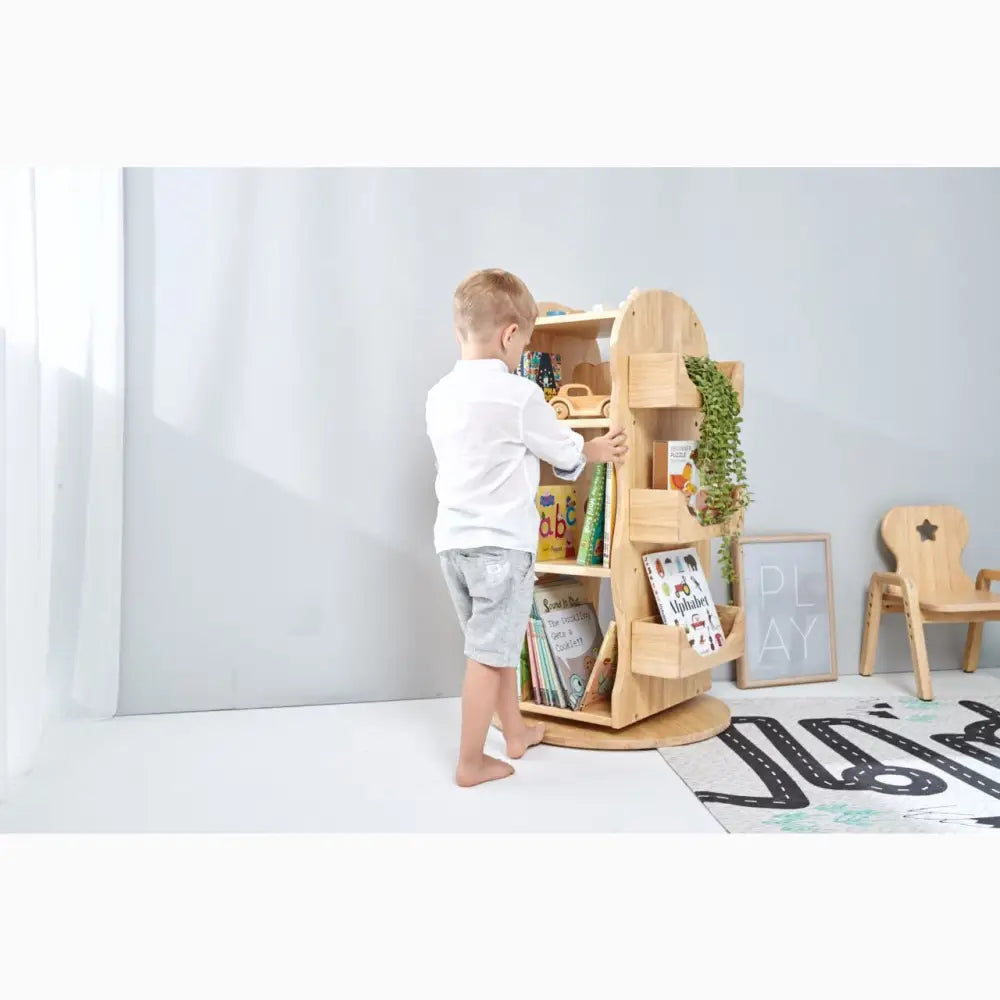 Wooden tree-shaped bookshelf with multiple shelves for storage.