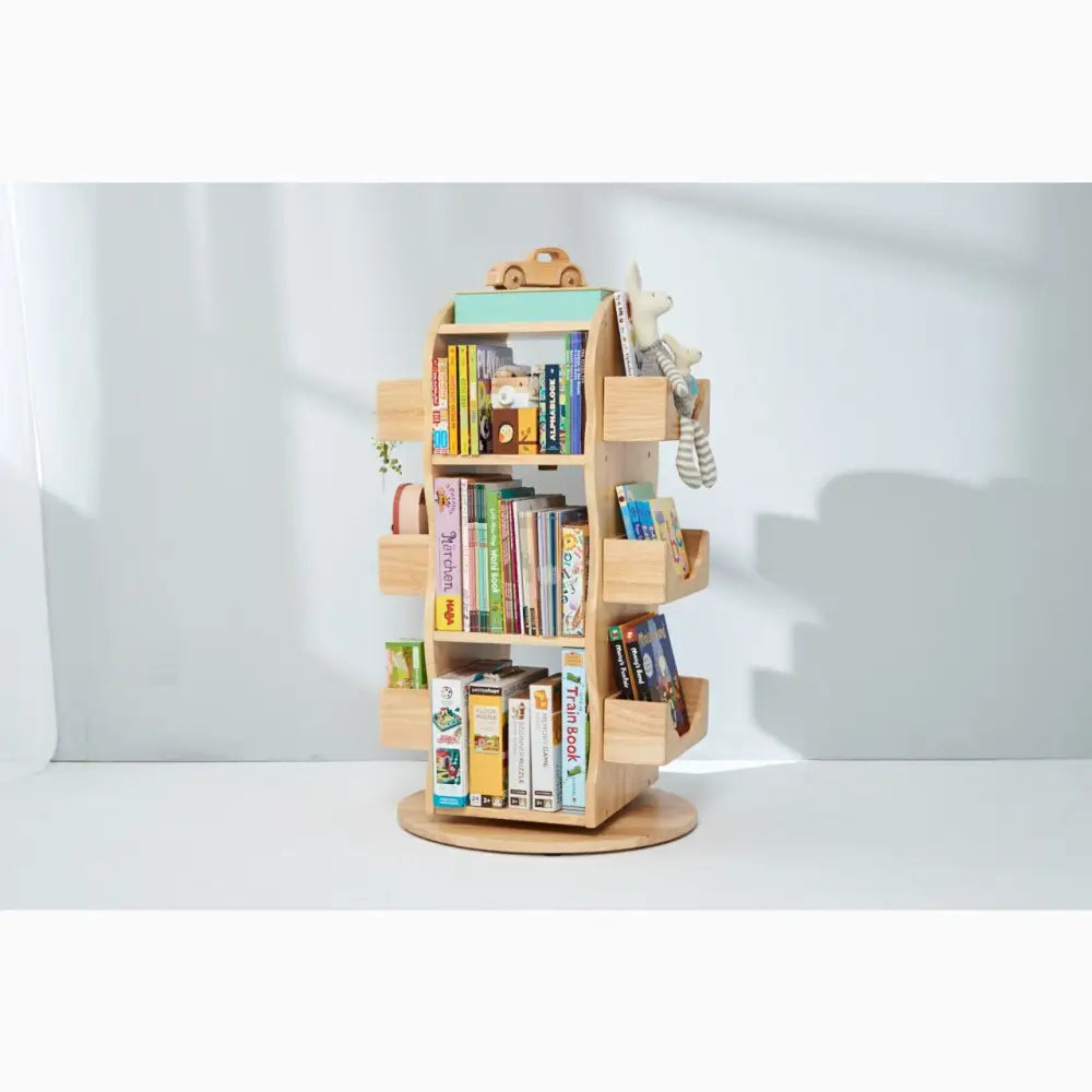 Rotating wooden bookshelf with multiple tiers for storing books and toys.