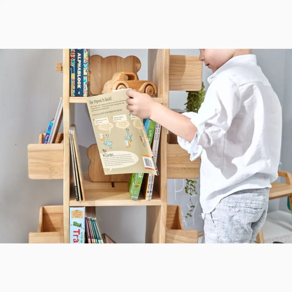 Wooden bookshelf with various compartments and storage spaces for books and toys.