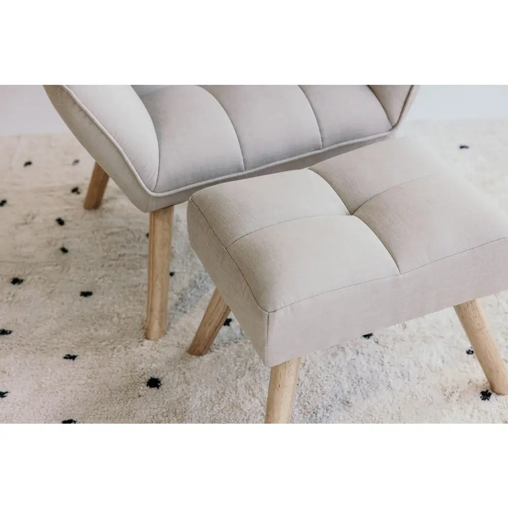 Upholstered chair with a matching footstool, both featuring light-colored fabric and wooden legs.