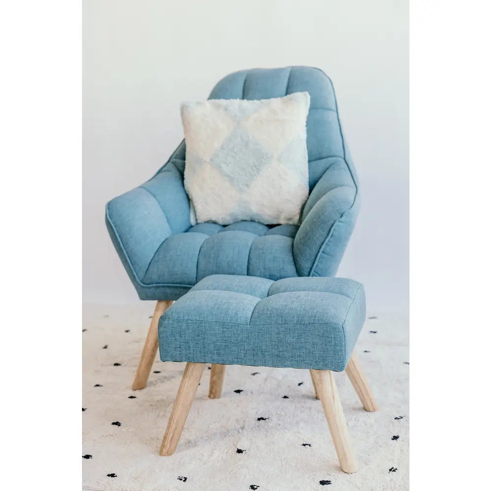 Light blue upholstered armchair with matching footstool and decorative pillow.