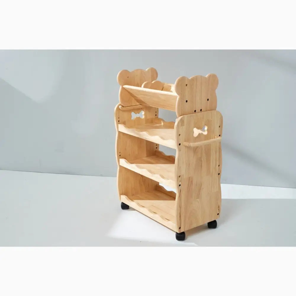 Wooden children’s bookshelf with bear-shaped sides and bow tie decorations.