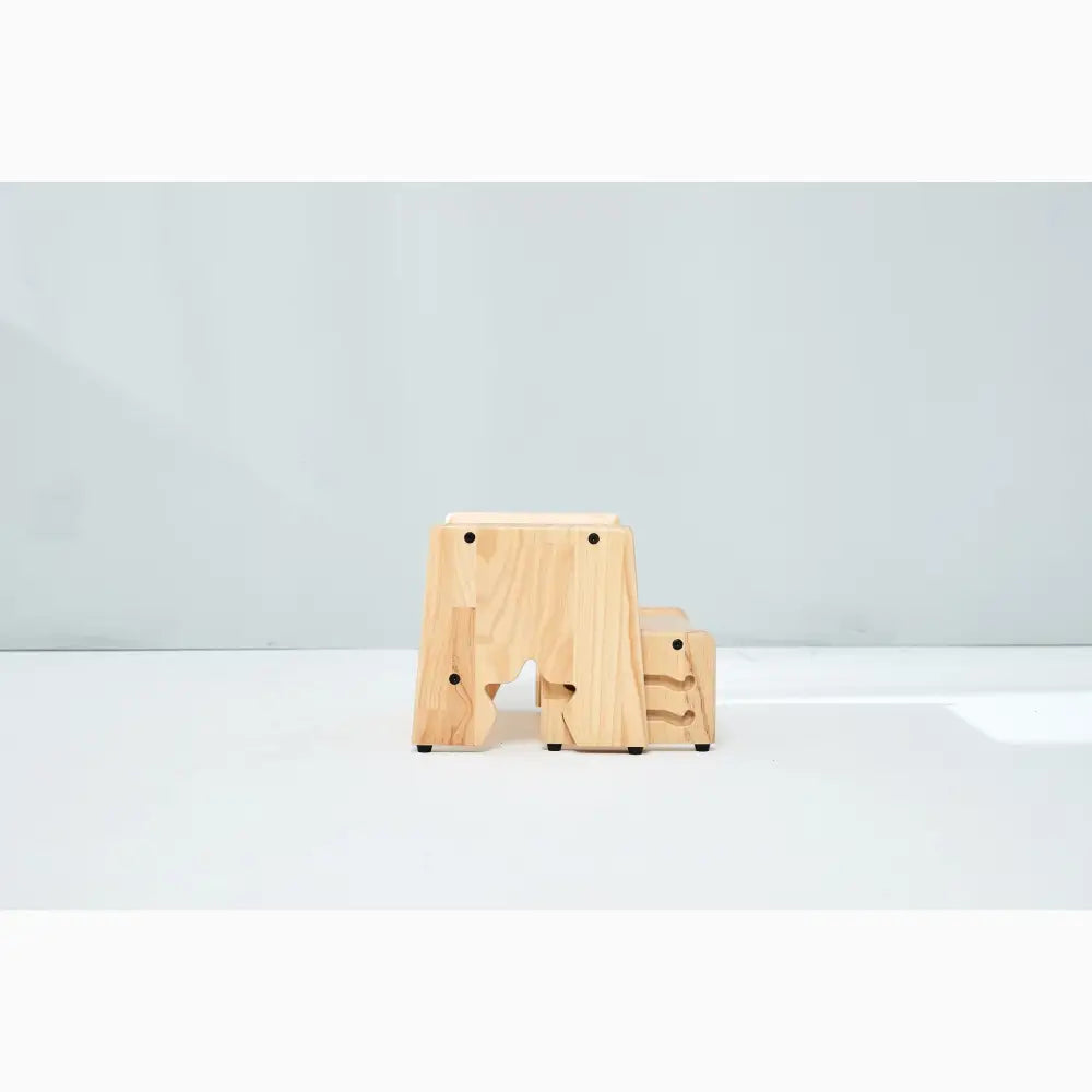 Wooden stool or step with a smaller companion piece beside it.