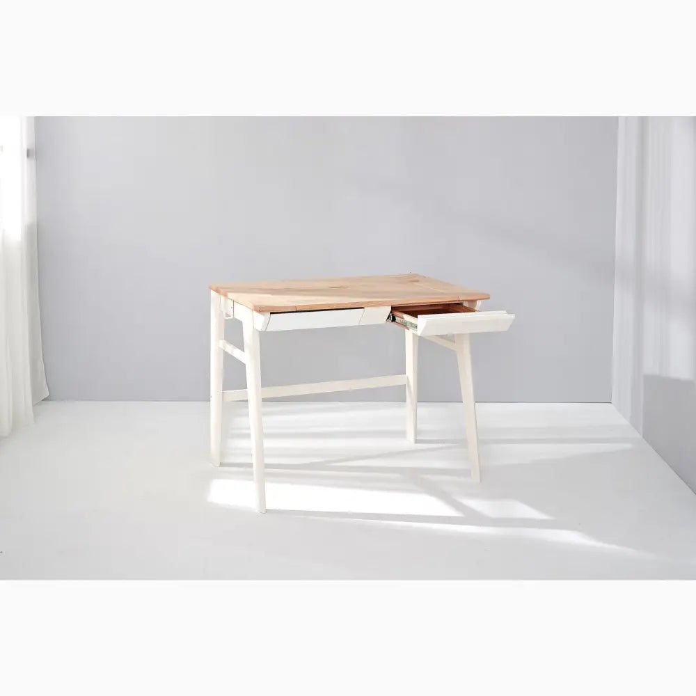 Minimalist desk with white legs and a wooden top featuring a built-in drawer.