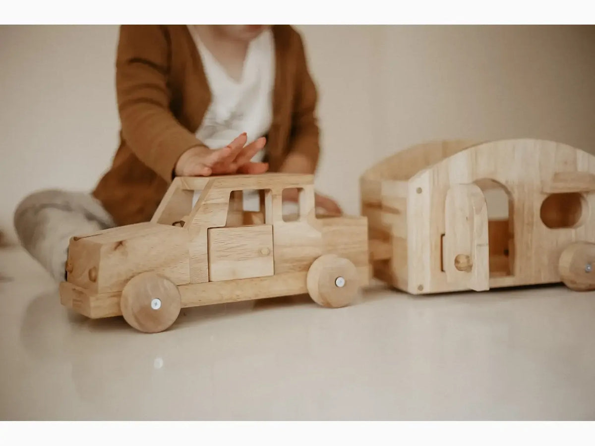 Wooden toy truck and camper.