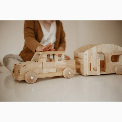 Wooden toy truck and camper.