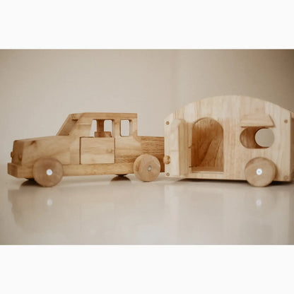 Wooden toy truck with camper.