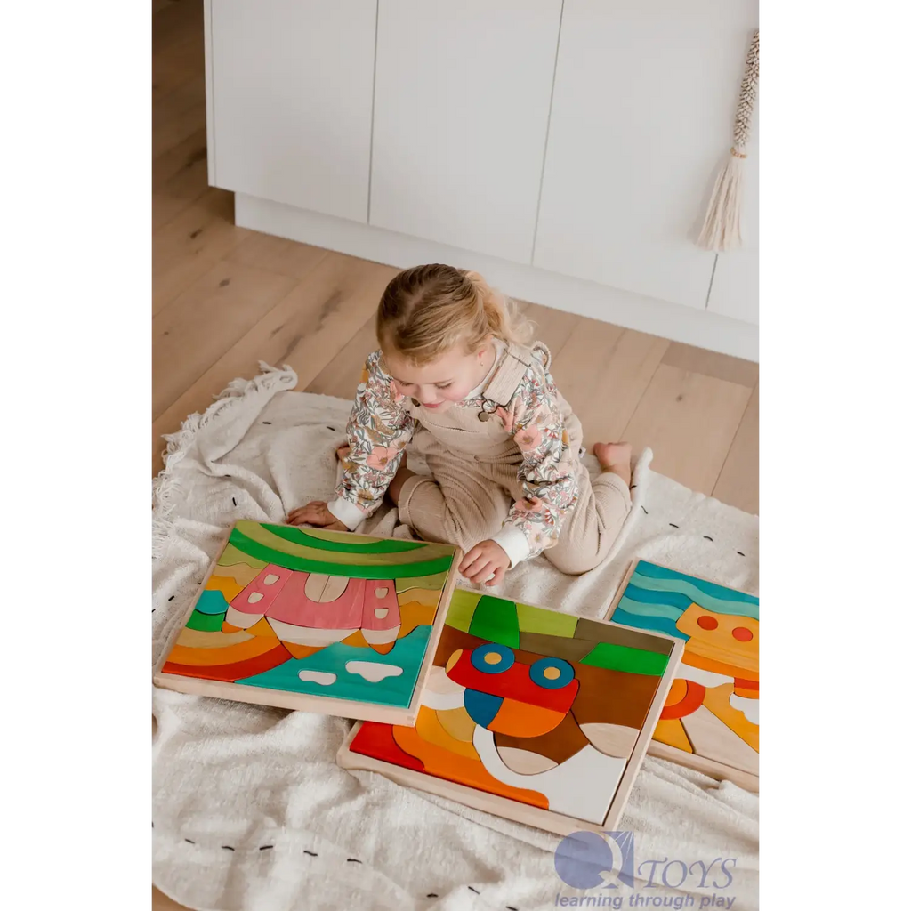 Toddler playing with colorful wooden puzzle pieces on a blanket.