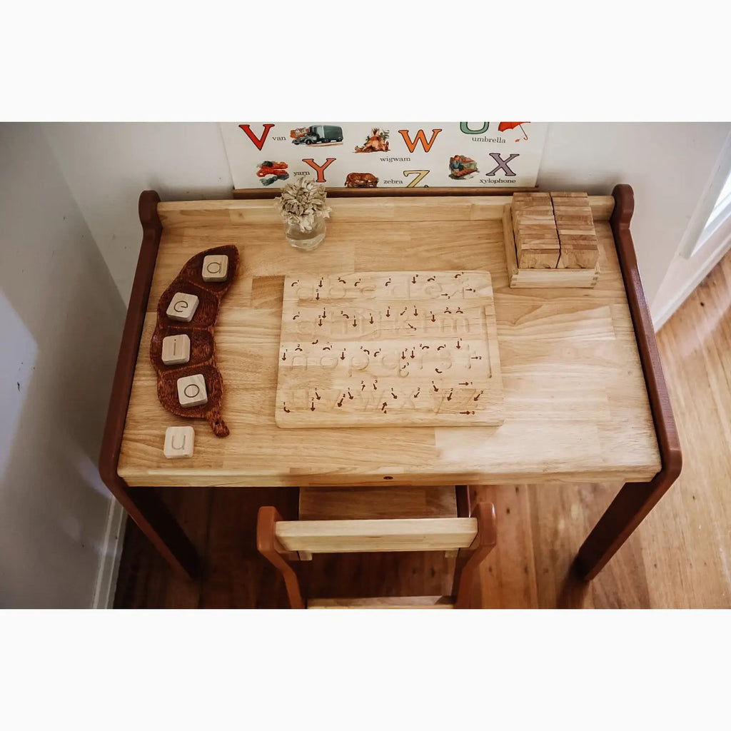 Wooden child’s desk with educational toys.