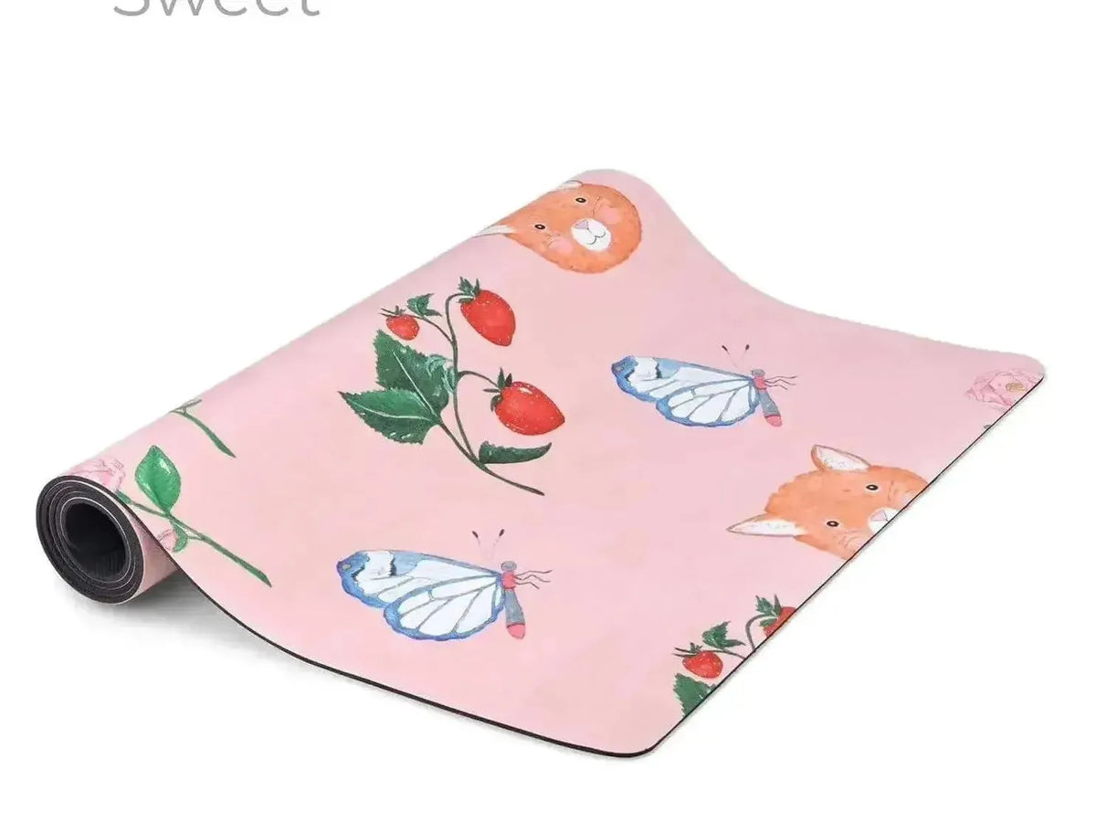 Yoga mat with a pink background featuring illustrations of butterflies, strawberries, and other nature-inspired designs.